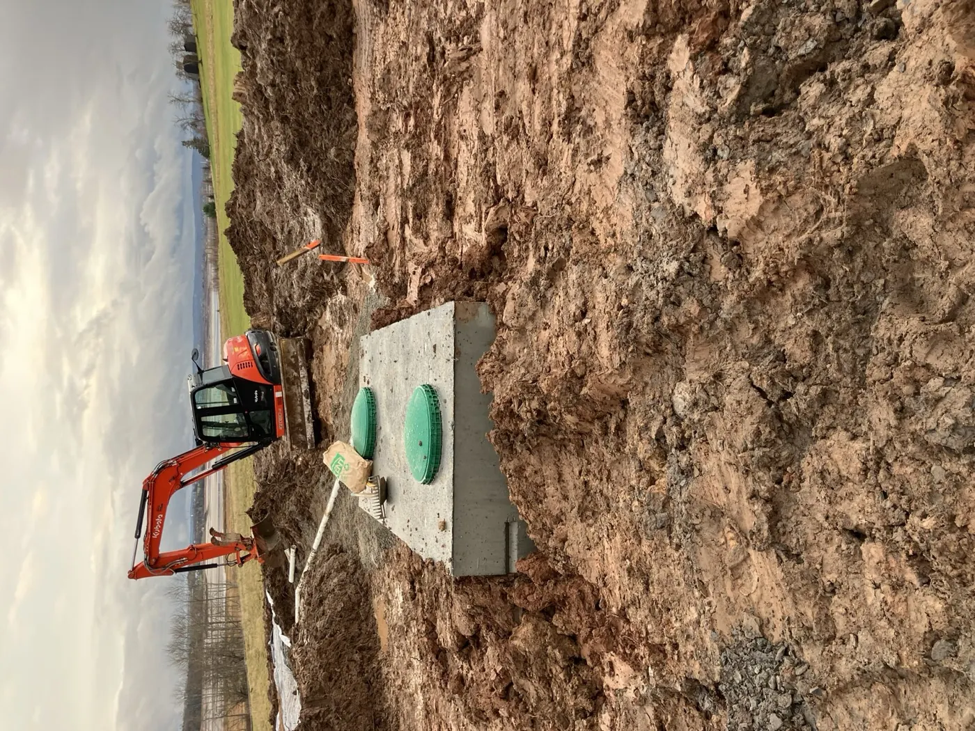 Septic system installation with an excavator on site