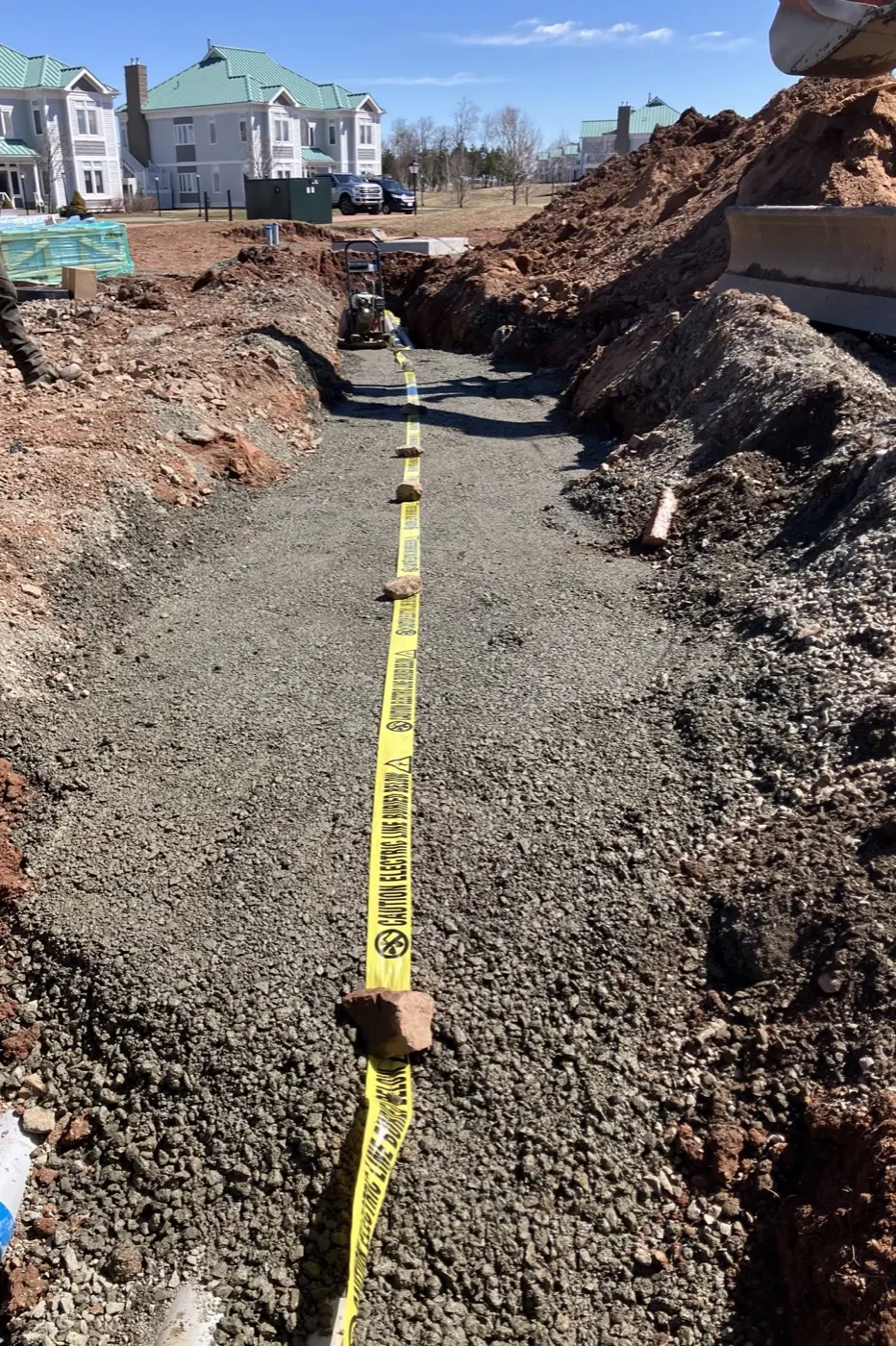 Gravel-lined utility trench prepared for installation
